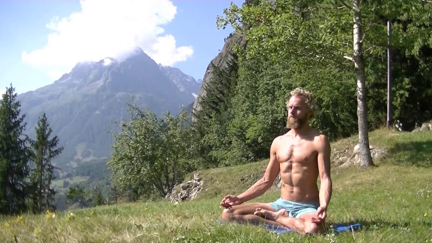yogi sitting in lotus praticing pranayama breathwork